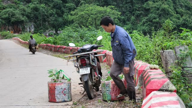 Man Standing By Loaded Motorbike