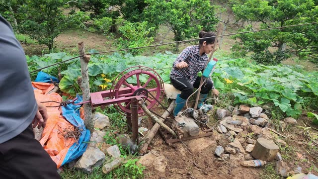 Woman Operating Old Water Pump