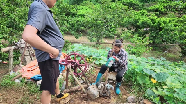 Man And Woman By Irrigation Pump