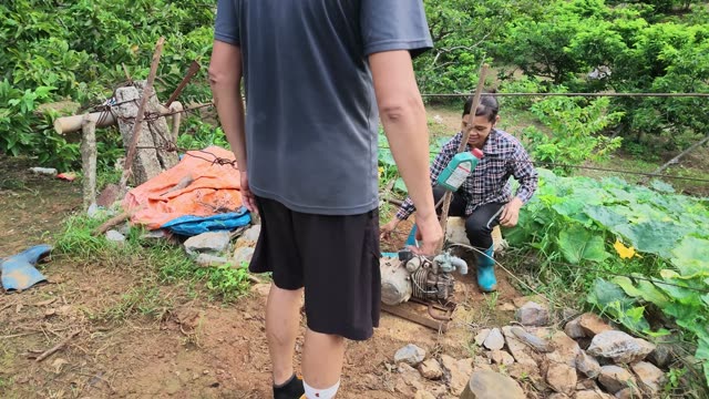 Man Watching Woman Operate Pump
