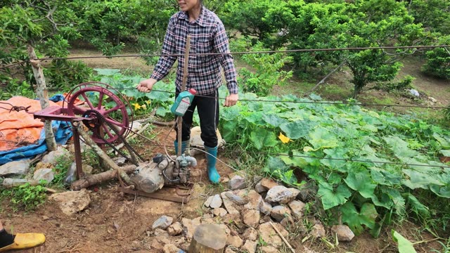 Woman Standing By Pump With Sprayer