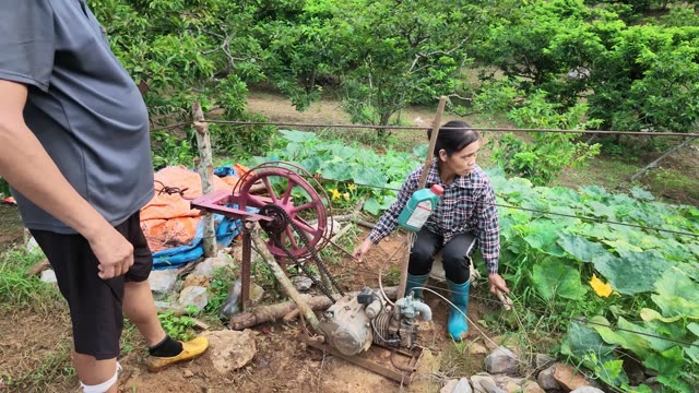 Two Farmers By Water Pump Machine
