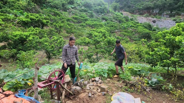 Woman Smiling By Pump In Garden