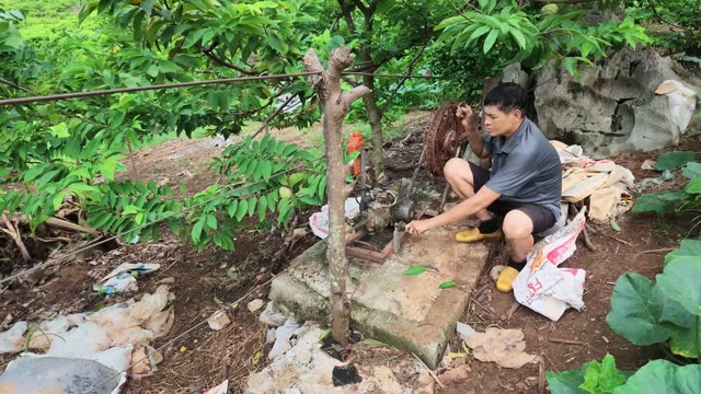 Man Crouching By Stone Pump Base