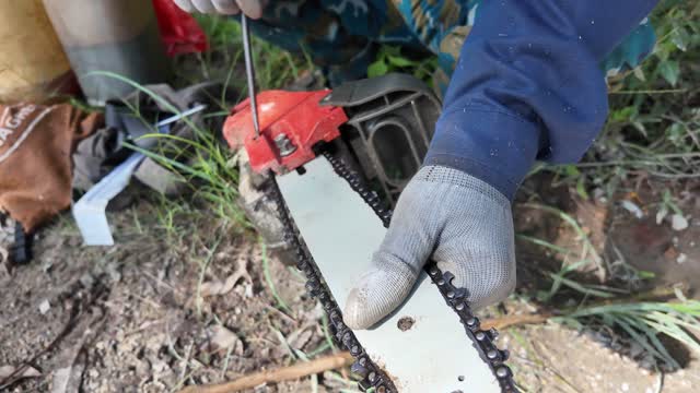 Adjusting Chainsaw Chain With Screwdriver