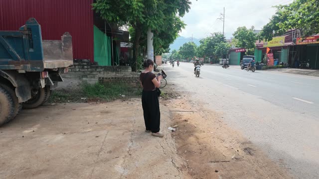 Man Standing By Motorbike And Baskets