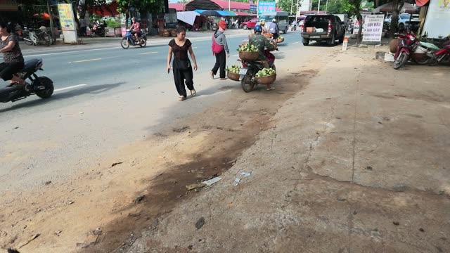 Women Walking With Loaded Cart