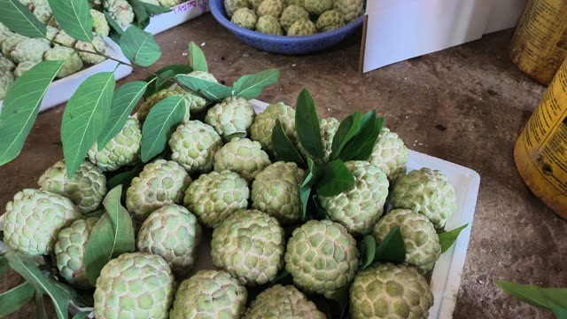 Man Arranging Custard Apple Basket