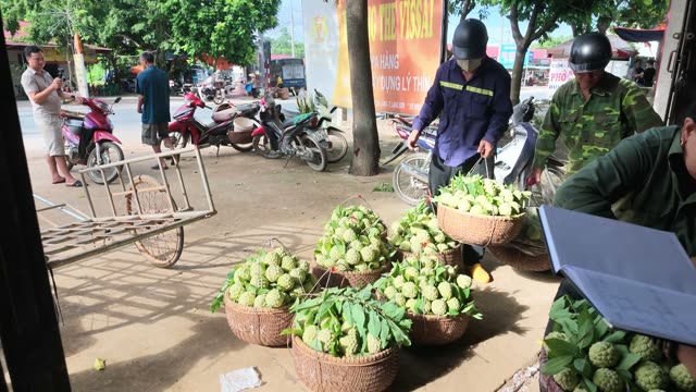 Men With Motorbikes By Fruit Baskets