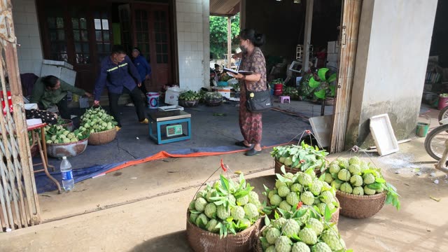 Woman Taking Notes Near Baskets