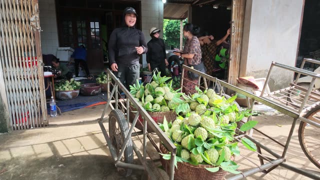 People Gathering By Loaded Cart