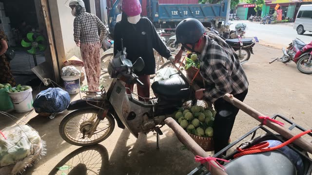 Man Attaching Basket To Motorbike