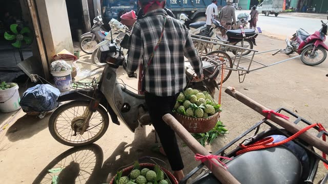Man Loading Motorbike With Baskets