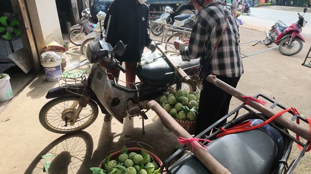 Men Preparing Loaded Motorbike