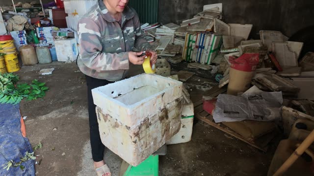 Man Walking With Basket By Boxes