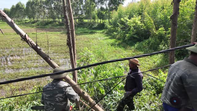 Workers Clearing Flooded Field Edge