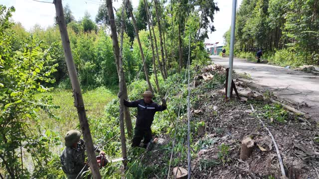 Villager Clearing Slope By Road