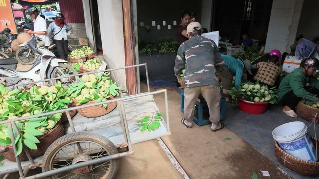 Man Pushing Cart Toward Doorway