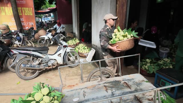Man Carrying Basket Toward Doorway