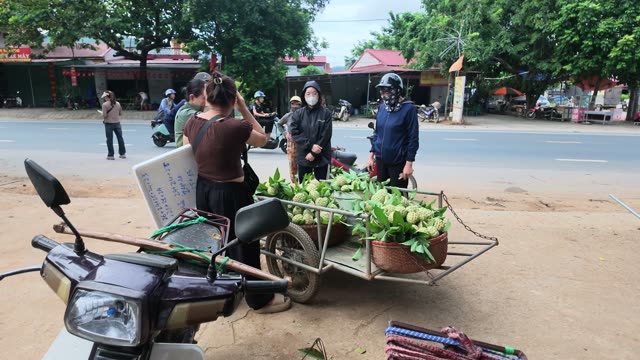 Woman Photographing Fruit Seller