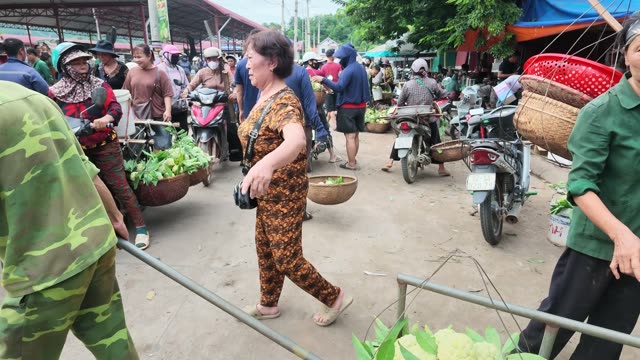 Woman Walking Through Busy Market