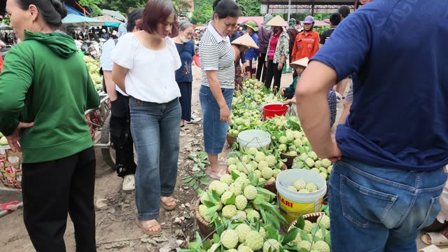 People Gathered At Market Stall