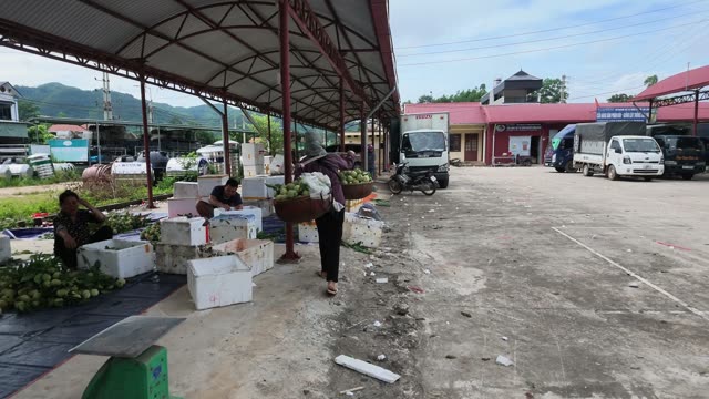 Man On Motorbike By Market Boxes