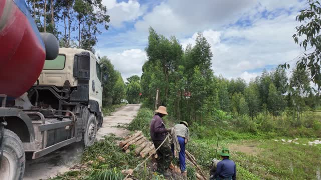 Loading Logs Beside Truck