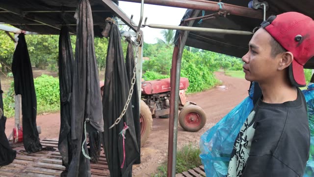Man By Hanging Black Bags