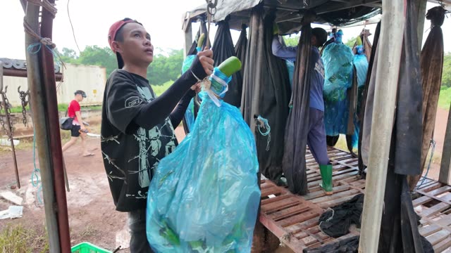 Man Attaching Bag To Hook