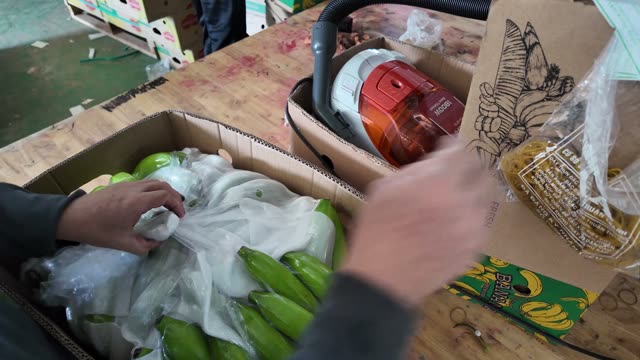 Worker Packing Bananas Into Box