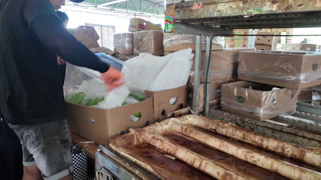 Worker Loading Bananas Into Lined Box