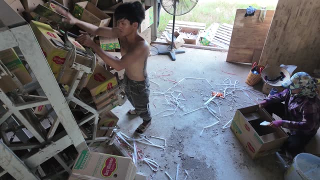 Worker Sorting Boxes Near Straps