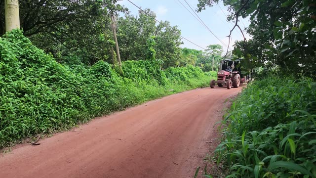 Tractor Driving Away On Plantation Road