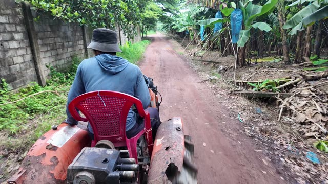Man Driving Tractor Down Road