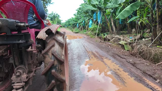 Tractor Driving Muddy Road