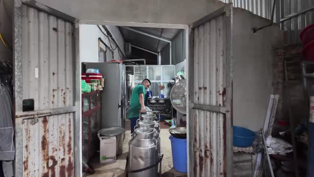 Worker Cleaning Milk Cans
