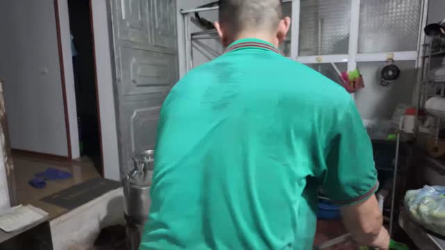 Worker Handling Milk Container