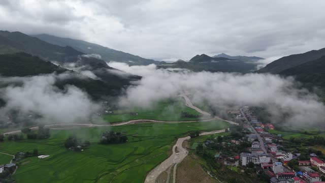 River Winding Through Misty Valley Town