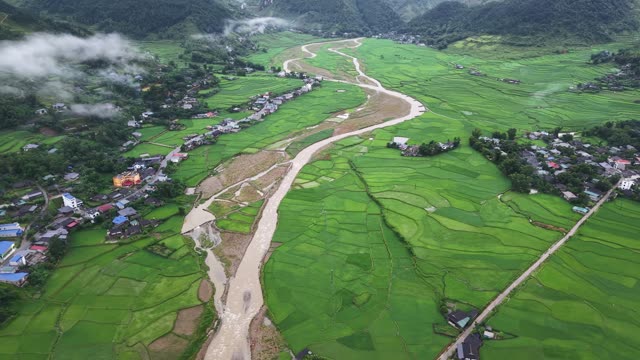 Wide River Valley Through Green Fields