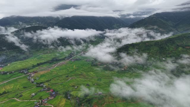 Village Road Beneath Foggy Mountains