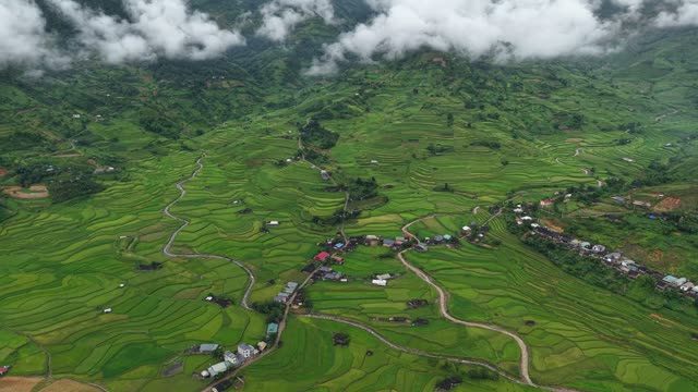 Terraced Village Beneath Rolling Clouds