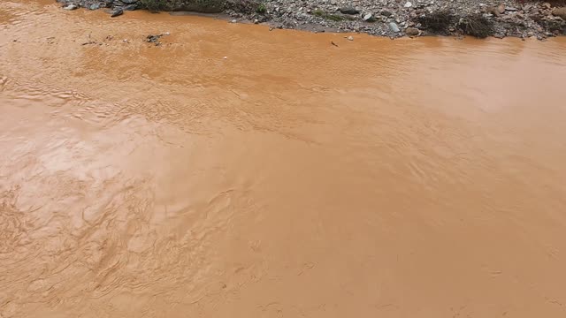 FPV Flying Low Over Muddy Water