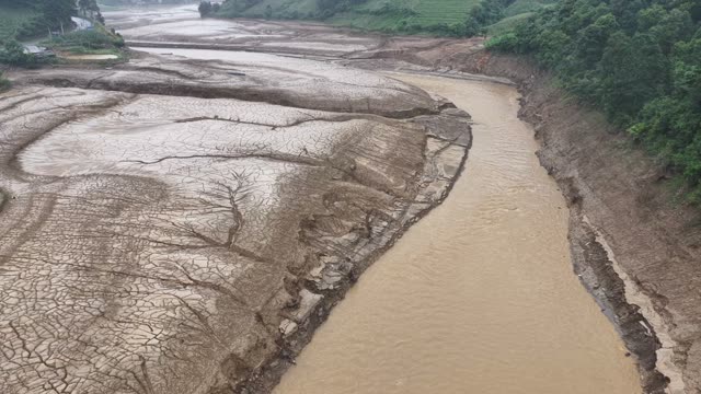 Cracked Riverbed Beside Muddy Water