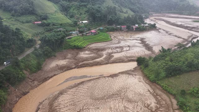 Riverside Village By Cracked Mudflat