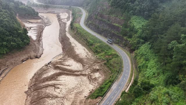 Mountain Road Beside Muddy River
