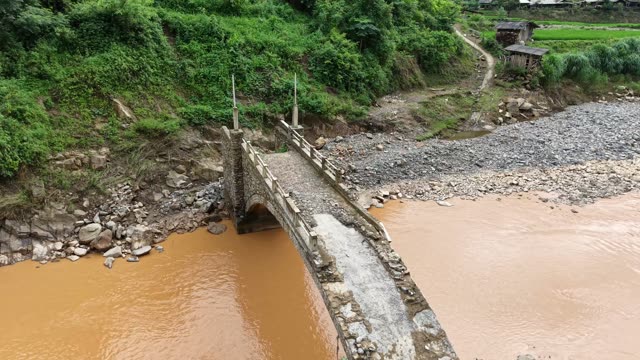 Arched Bridge Beside Rocky Riverbank