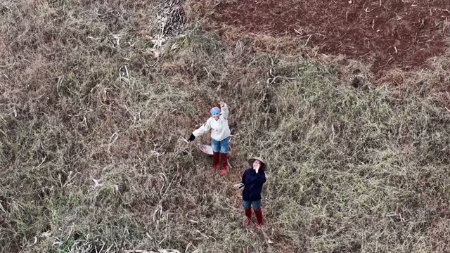 Two Farmers Standing In Dried Field