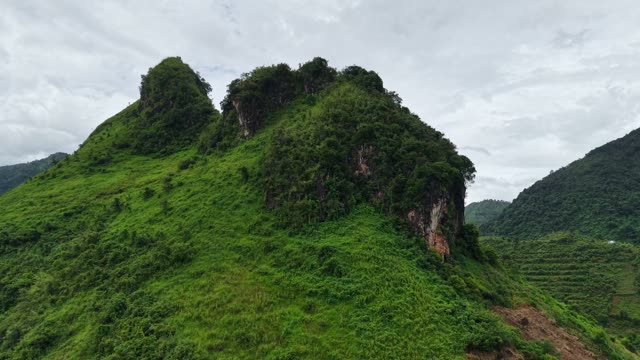 Green Karst Peak Above Terraces