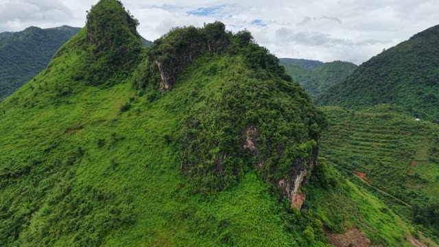 Rugged Peak Beside Terraced Slope